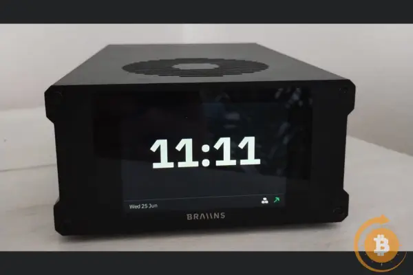 Braiins Mini Miner 101 displaying 11:11, securing Bitcoin mining network