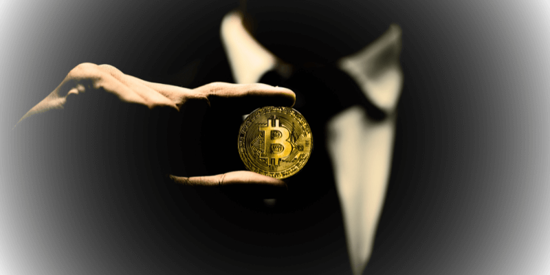 Bitcoin Whitepaper with a faceless man holding a BTC coin